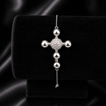 Pulsera con dije grande de cruz formada por esferas pulidas y con circonita